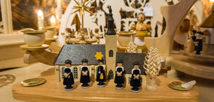 Geschnitze Sternsinger vor einer Kirche